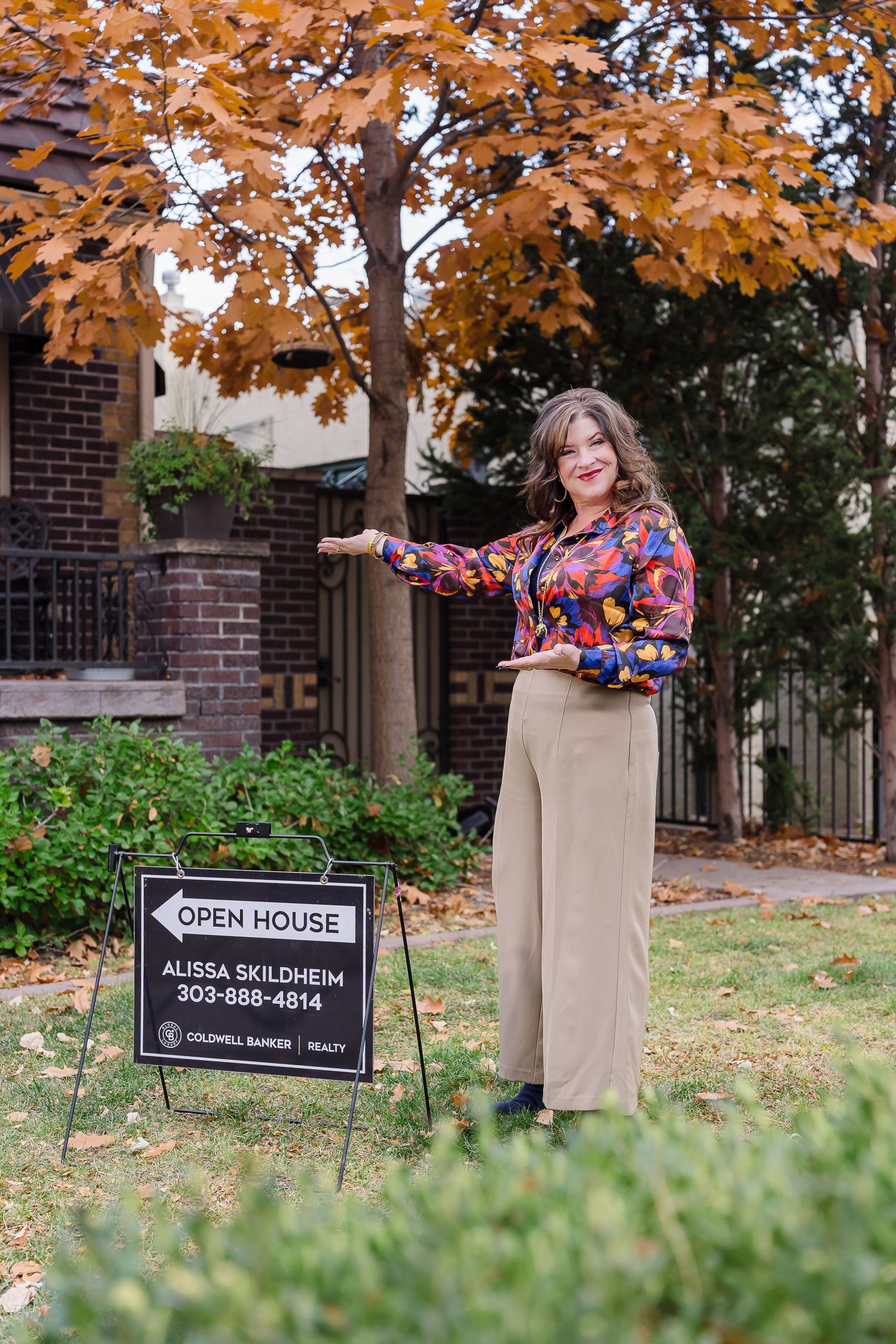 enver Realtor Alissa Skildheim with Global Luxury real estate branding sign in Cherry Creek office